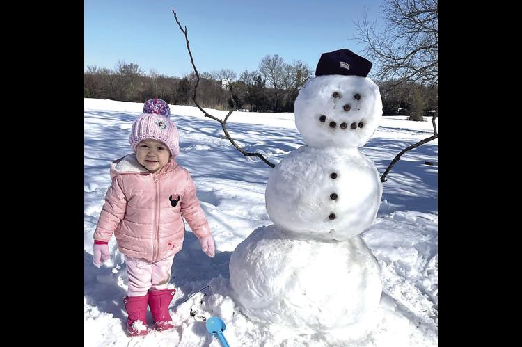 HER FIRST SNOW. 2 1/2 year old Reikyn Griffith said Elsa brought the snow, so when her dad helped her build a snowman, she named it Olaf.