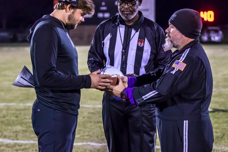 Coach Cater checks the game ball before layin’ a good ole country whoopin’ on Tishomingo