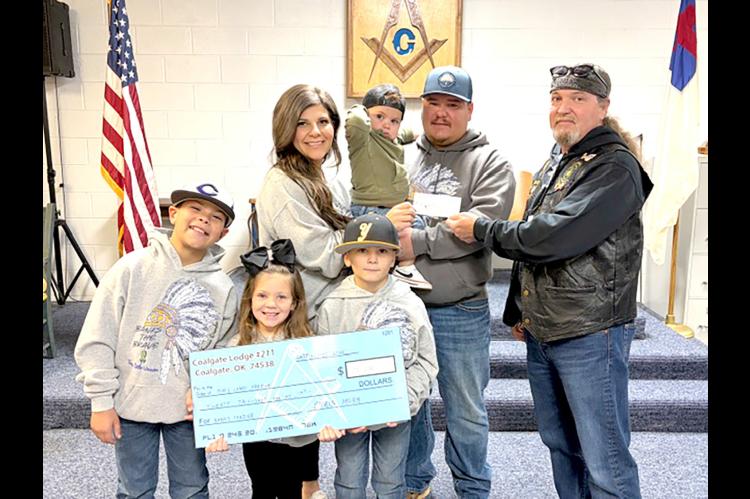 A HELPING HAND — Coalgate Masonic Lodge #211 presented a $20,000 check to the BW and Landi Frazier family on November 22 to help with 2-yearold Banks’ medical expenses. Coalgate First Baptist Church along with friends and family sponsored a benefit fu