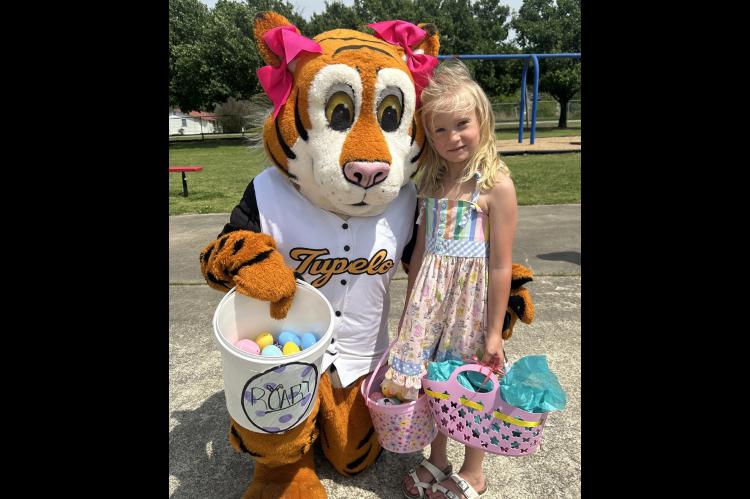 Kindergartener Brayley Ybarra with Roary the Tiger at Elementary Easter Party.