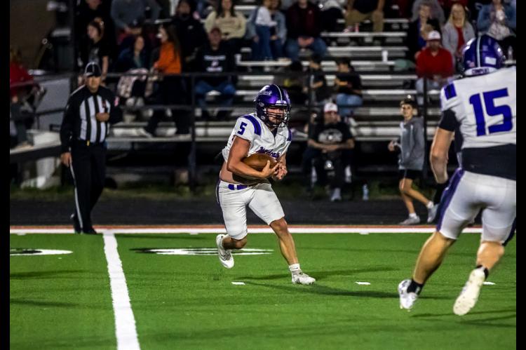 Kyler Woods cuts back across the turf for a gain on the play.
