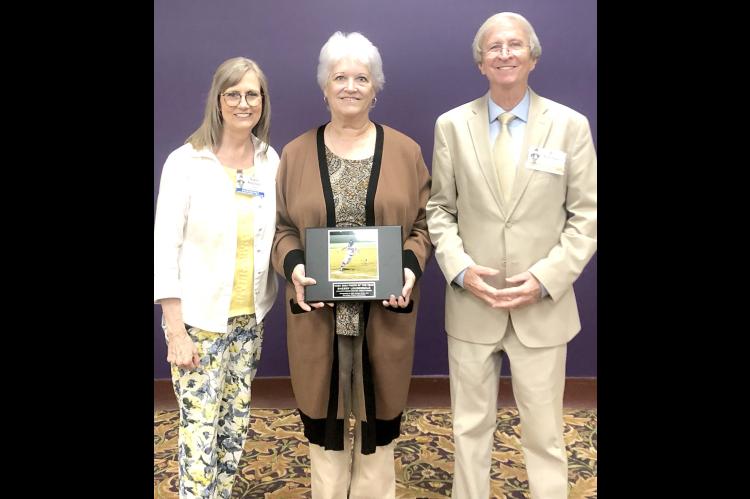 Sherry Loudermilk was honored Saturday as the OGE Photographer of the Year for weekly newspapers during the annual Oklahoma Press Convention held at the Grand Casino Hotel in Shawnee. Sherry is pictured at left with the photo that garnered her award and a