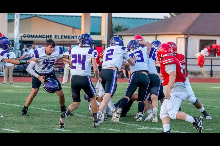 Ethan Nelson loses his helmet as the Wildcats swarm Comanche.