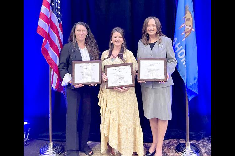 Coal County Deputy Clerk Autumn Haney is congratulated after receiving her certificates for Basic, Advanced I, and Advanced II accreditations for County Clerks through the OSU County Training Program by County Training Program Director Jean Hinkle (left) 