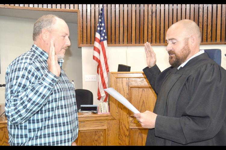 District Judge Joe Trail administers Bryan Jump’s oath of office for interim sheriff