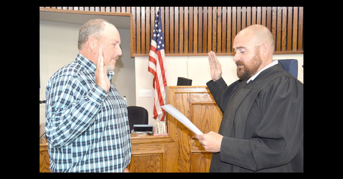 District Judge Joe Trail administers Bryan Jump’s oath of office for interim sheriff
