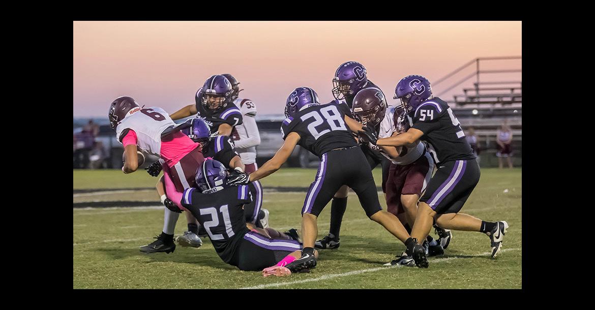 Wildcats swarm Pocola for a tackle led by Travyn Hansel.