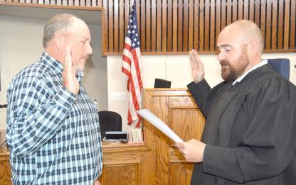District Judge Joe Trail administers Bryan Jump’s oath of office for interim sheriff