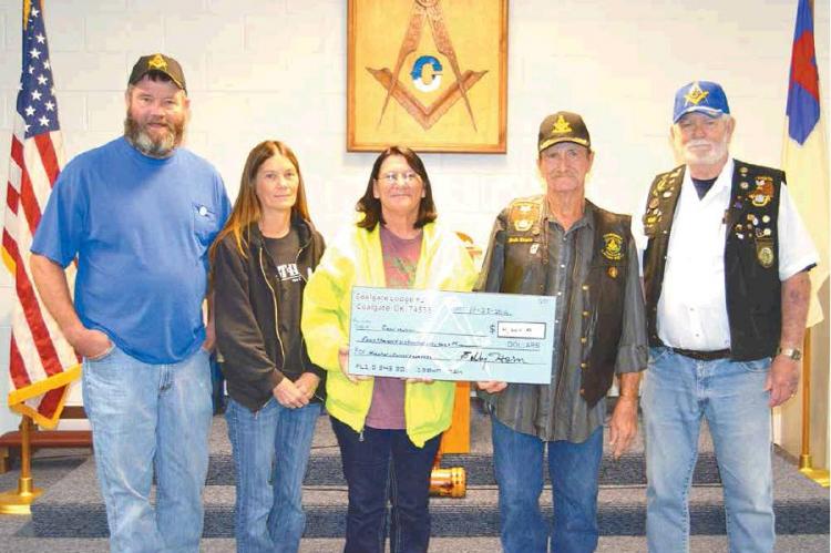 COALGATE MASONIC LODGE #211 presents a check in the amount of $4,664 to Carol Melton to help with medical and funeral expenses for her late husband, Darrell Melton. The check represents funds raised at a spaghetti dinner in November. From left – Mason/b Article Image Alt Text