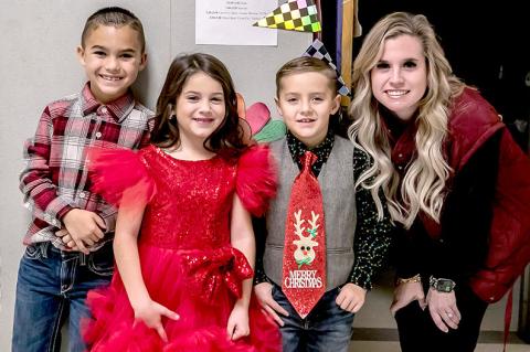 Mrs. Bowker was happy to get a picture with such sharply-dressed kids at the Emerson Elementary Christmas party. She is pictured above with Asher Blue, Whitley Caraway, and Rhett Battles.
