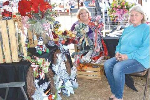 AMISH SCHOOL AUCTION— Mergie Bergman, Coalgate, left, and Beth Nelson, Olney, in their “Prayerful Pretties” booth at the Amish School Auction. For more information, call Mergie at 580-258-1947