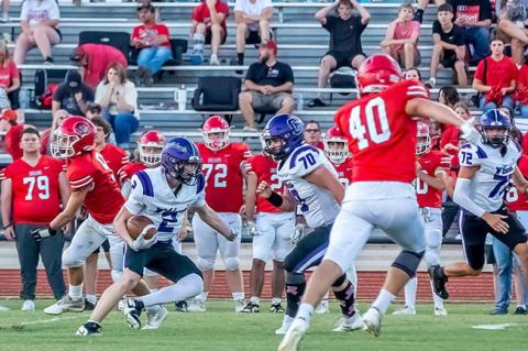 Davis Grant gets a solid block from Axel McNutt as he cuts to find his lane.