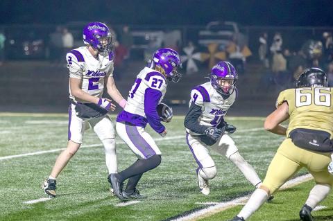 Kyler Woods hands off to Rowdy Hemphill who looks to Bryson Stowe to block.