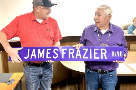 Mayor Elkins presents James Frazier with the new street sign which will bear his name