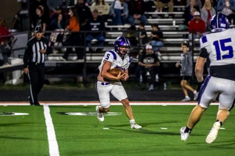 Kyler Woods cuts back across the turf for a gain on the play.