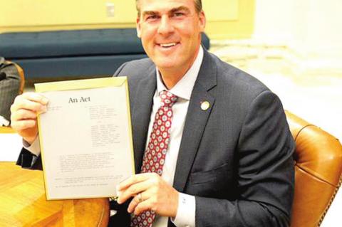 Gov. Stitt signs bill into law making