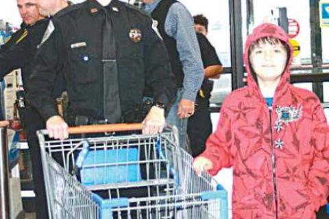 Coal County Sheriff’s Deputy Kolton Parker and partner Landom Street get ready to do some fun shopping at Walmart during the Shop with a Cop Christmas shopping spree.