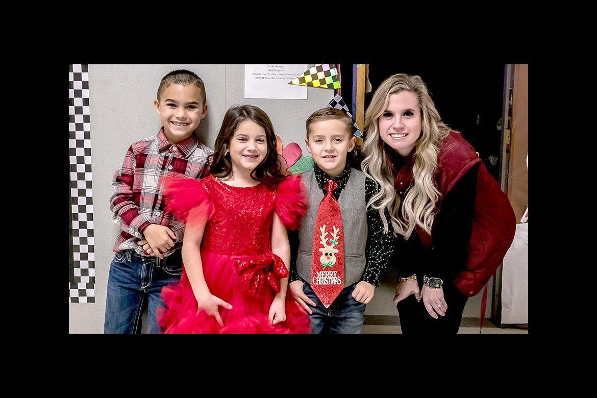 Mrs. Bowker was happy to get a picture with such sharply-dressed kids at the Emerson Elementary Christmas party. She is pictured above with Asher Blue, Whitley Caraway, and Rhett Battles. Mrs. Bowker was happy to get a picture with such sharply-dressed kids at the Emerson Elementary Christmas party. She is pictured above with Asher Blue, Whitley Caraway, and Rhett Battles.