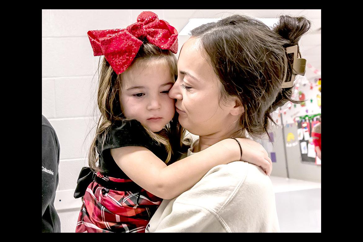 Rori Thompson gets a sweet Christmas hug from Shacole Thompson at the Emerson Elementary Christmas party Rori Thompson gets a sweet Christmas hug from Shacole Thompson at the Emerson Elementary Christmas party